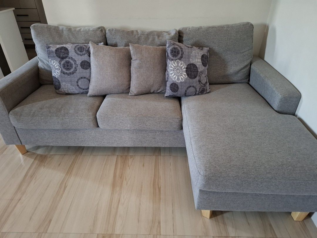 Gray Sectional Sofa with Chaise Lounge (Category: Sofas) located in Calamba. Submitted by iammommygeline (Listing ID 1433655477, Image 2). Description: bagong washed and clean . no stain. no issue. 💯 like new condition - Gray sectional sofa with right-side chaise (pwede din ilipat sa left side convertible naman) - Features three seat cushions - Includes three neutral and two patterned throw pillows - Wooden legs - Ideal for living or family room