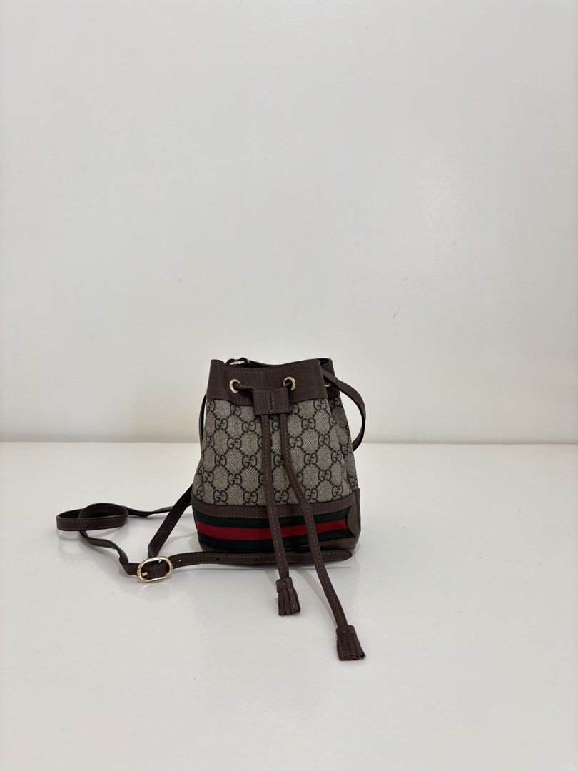 Gucci GG Supreme Bucket Bag (Category: Luxury Bags & Wallets) located in Dagupan City. Submitted by raregrail.co (Listing ID 1433637451, Image 1). Description: - Authentic Gucci bucket bag - Iconic GG Supreme canvas - Drawstring closure - Brown leather strap - Red and green stripe detail - Light-colored fabric lining - Gold-tone buckle - Interior leather tag with Gucci logo and "Made in Italy".