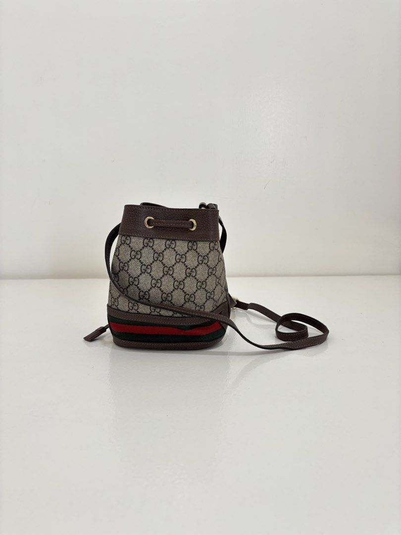 Gucci GG Supreme Bucket Bag (Category: Luxury Bags & Wallets) located in Dagupan City. Submitted by raregrail.co (Listing ID 1433637451, Image 2). Description: - Authentic Gucci bucket bag - Iconic GG Supreme canvas - Drawstring closure - Brown leather strap - Red and green stripe detail - Light-colored fabric lining - Gold-tone buckle - Interior leather tag with Gucci logo and "Made in Italy".