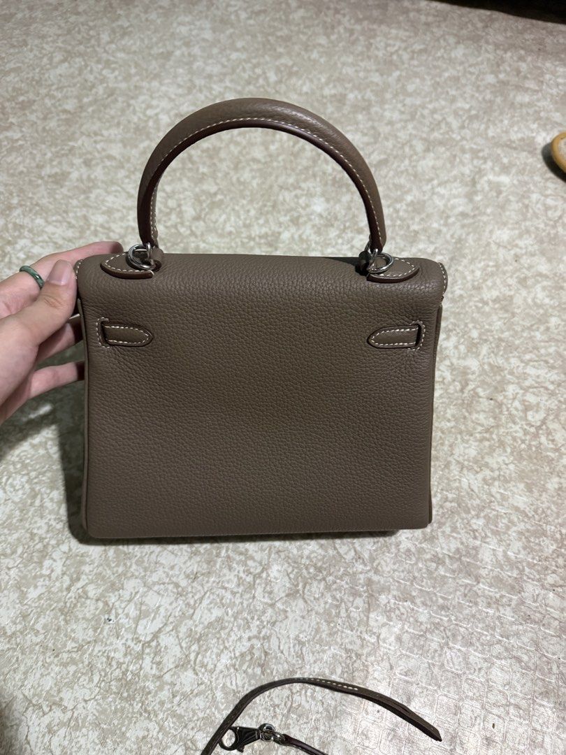 Hermes Kelly 25 Retourne (Category: Luxury Bags & Wallets) located in Lipa City. Submitted by chrs.bags (Listing ID 1433725478, Image 3). Description: Kelly 25 handbag sourced from Japan - Color: Etoupe - Features: - Top handle - Detachable shoulder strap - Flap closure with turn lock - Palladium hardware - Interior pouch - contrast white stitching details - Brand name visible on interior and strap - Condition: Slight sign of use overall good 10/