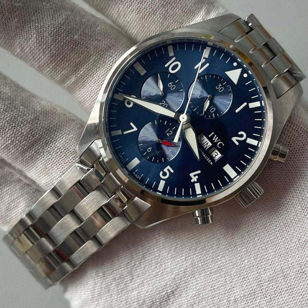 IWC Pilot's (Category: Luxury Watches) located in Manila. Submitted by kaneramos031818 (Listing ID 1433762465, Image 2). Description: IWC Pilot's Chronograph watch with a blue dial and stainless steel bracelet. Includes an extra blue leather strap. Features chronograph subdials and a day-date display. Comes with a wooden box..
