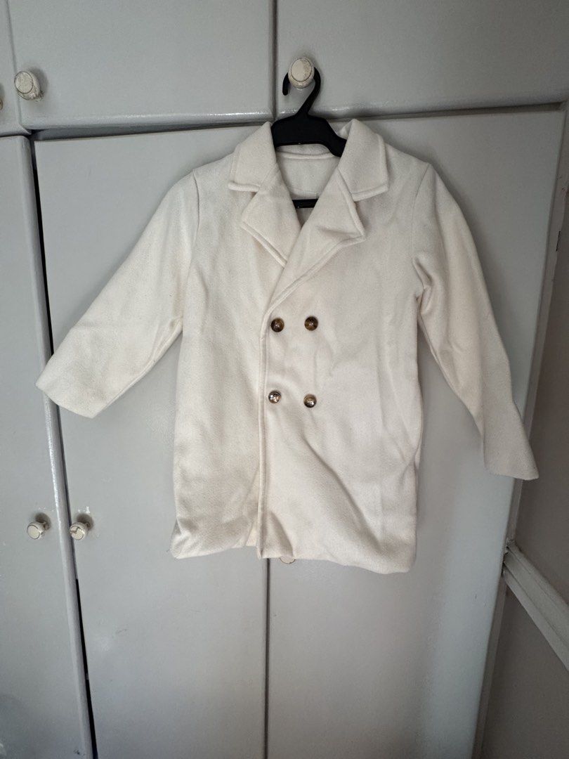 Kids trench coat (Category: Coats, Jackets and Outerwear) located in Pasig City. Submitted by heydeclutterist2nd (Listing ID 1433671556, Image 1). Description: Trench coat for kids Age 6-8 Length-24 Width-16 Shoulder-13 Rfs: decluttering .