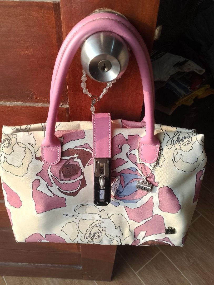 La Bagagerie Floral Handbag (Category: Tote Bags) located in Bulacan. Submitted by CatchyChic (Listing ID 1433675610, Image 1). Description: - La Bagagerie handbag - Floral pattern in pink and cream - Pink handles - Lock closure - Silver-tone hardware - Includes a small interior pocket with brand tag - Features a small charm - Minor fabric stains present.