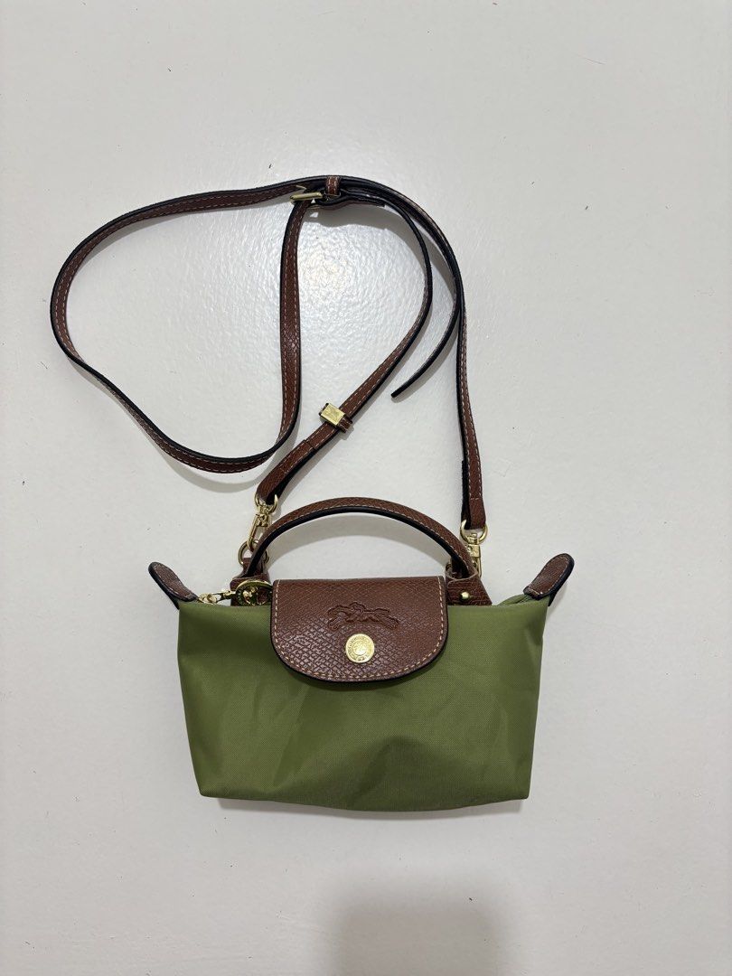 Longchamp Le Pliage Cuir Mini Top Handle Bag (Category: Luxury Bags & Wallets) located in Dagupan City. Submitted by raregrail.co (Listing ID 1433698351, Image 2). Description: - Authentic Longchamp Le Pliage Cuir Mini Top Handle Bag - Color: Olive Green - Features: Brown leather flap and handle, detachable shoulder strap - Made in France - Closure: Zip and snap closure - Interior tag with Longchamp Paris logo.