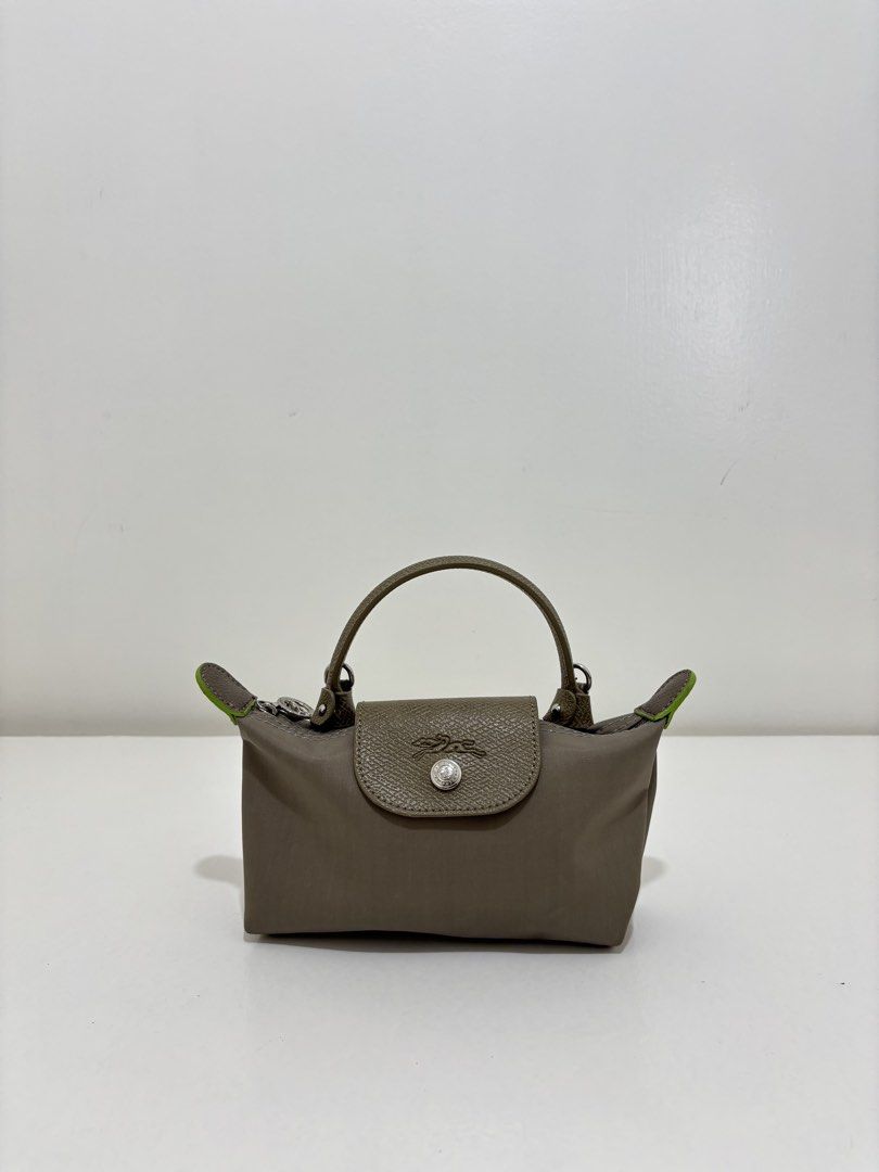 Longchamp Le Pliage Cuir XS Handbag (Category: Luxury Bags & Wallets) located in Dagupan City. Submitted by raregrail.co (Listing ID 1433698778, Image 1). Description: - Authentic Longchamp Le Pliage Cuir XS handbag - Top handle and detachable shoulder strap - Flap closure with snap button - Interior includes a small pocket - Made in France - Neutral color with green accents.
