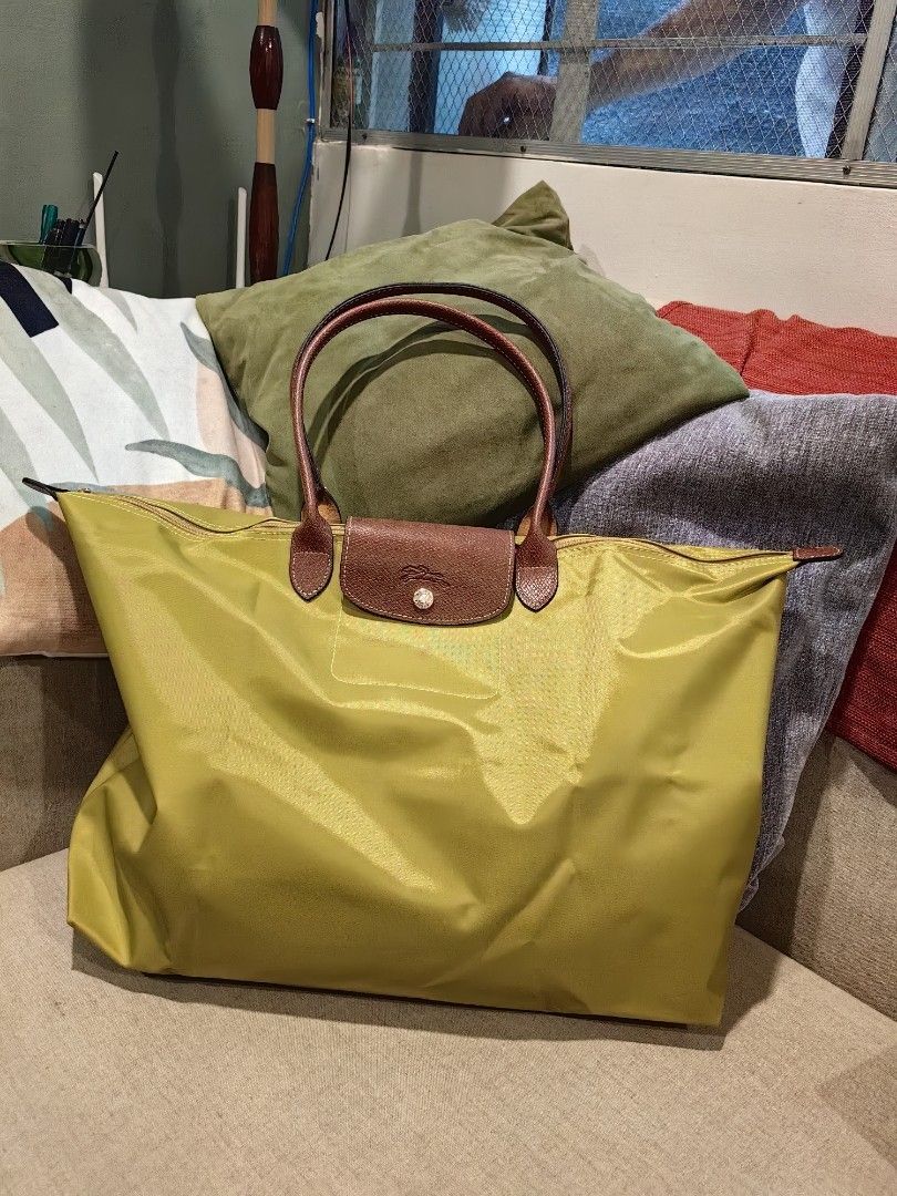 Longchamp Le Pliage Travel Handbag (Category: Luxury Bags & Wallets) located in Quezon City. Submitted by flat.earther23 (Listing ID 1433602710, Image 1). Description: - Authentic Longchamp Le Pliage - Brown leather handles - Button closure - Longchamp zipper charm - Made in Tunisia - White interior - Stylish and practical for everyday use - Available Colors Mustard yellow - SOLD Cognac British Green.