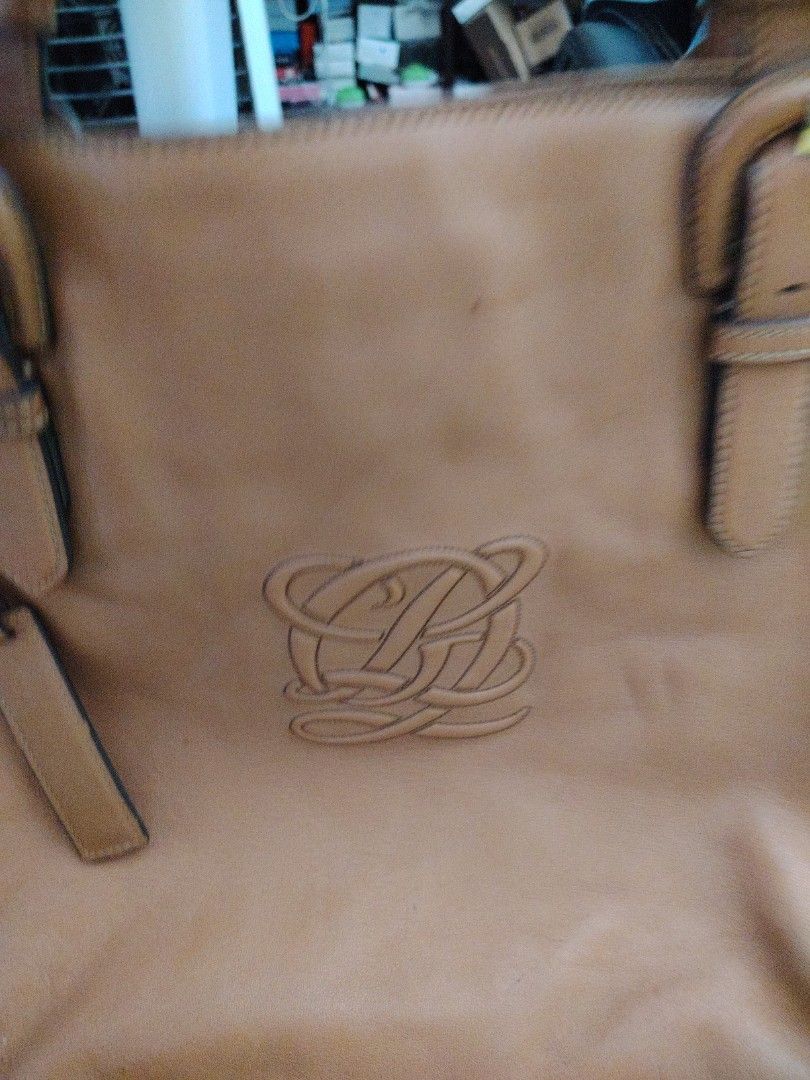 Louis Quatorze Leather Tote Bag (Category: Tote Bags) located in Taguig. Submitted by roxie0419 (Listing ID 1433651390, Image 2). Description: - Authentic Louis Quatorze tote bag - Genuine leather - Color: Tan - Spacious interior - Multiple compartments - Patterned lining - Detachable brand tag - Embossed logo - Double handles - Decorative buckles - Metal studs on the bottom SF c/o buyer MOP GCash or Maya COP via LBC.