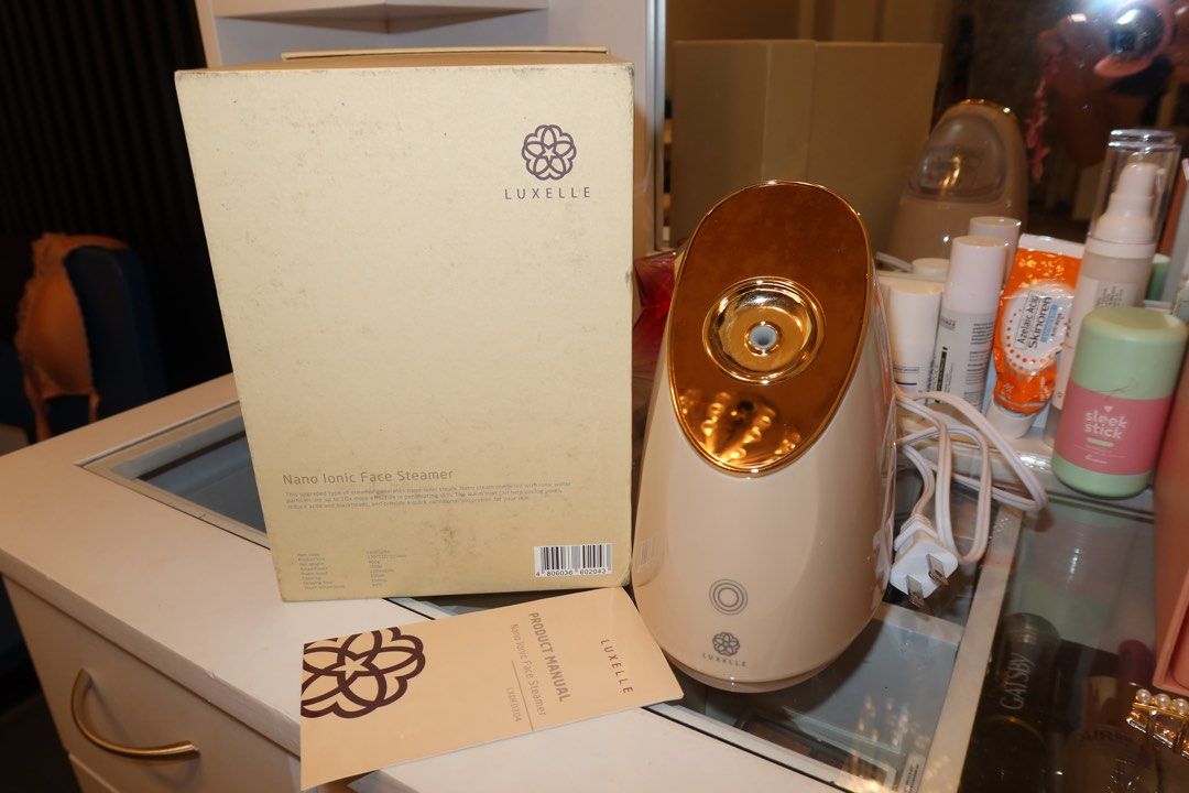 Luxelle Nano Ionic Face Steamer (Category: Face Care) located in Taguig. Submitted by mommae_preloved (Listing ID 1433703574, Image 1). Description: - Luxelle Nano Ionic Face Steamer - Includes original box and manual - Color: Beige with gold accents - Features the Luxelle logo on the box.