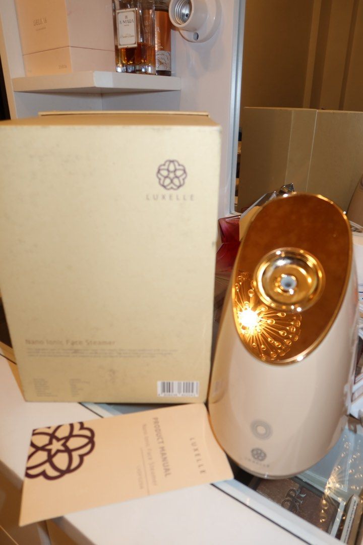 Luxelle Nano Ionic Face Steamer (Category: Face Care) located in Taguig. Submitted by mommae_preloved (Listing ID 1433703574, Image 2). Description: - Luxelle Nano Ionic Face Steamer - Includes original box and manual - Color: Beige with gold accents - Features the Luxelle logo on the box.