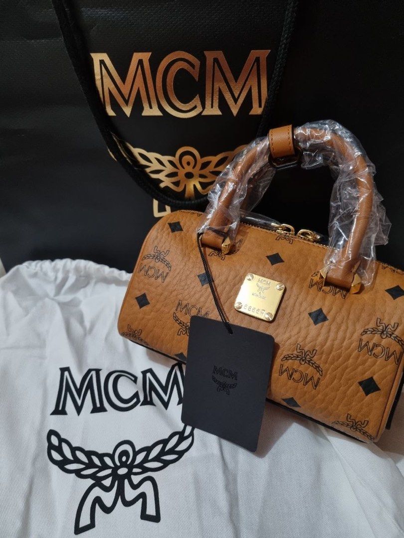 MCM Mini Boston Bag (Category: Luxury Bags & Wallets) located in Quezon City. Submitted by ejay75 (Listing ID 1433658884, Image 1). Description: - Authentic MCM mini Boston bag - Iconic MCM logo print - Top handle - Includes dust bag and tag - Handle still wrapped in plastic - Perfect for everyday or special occasions.