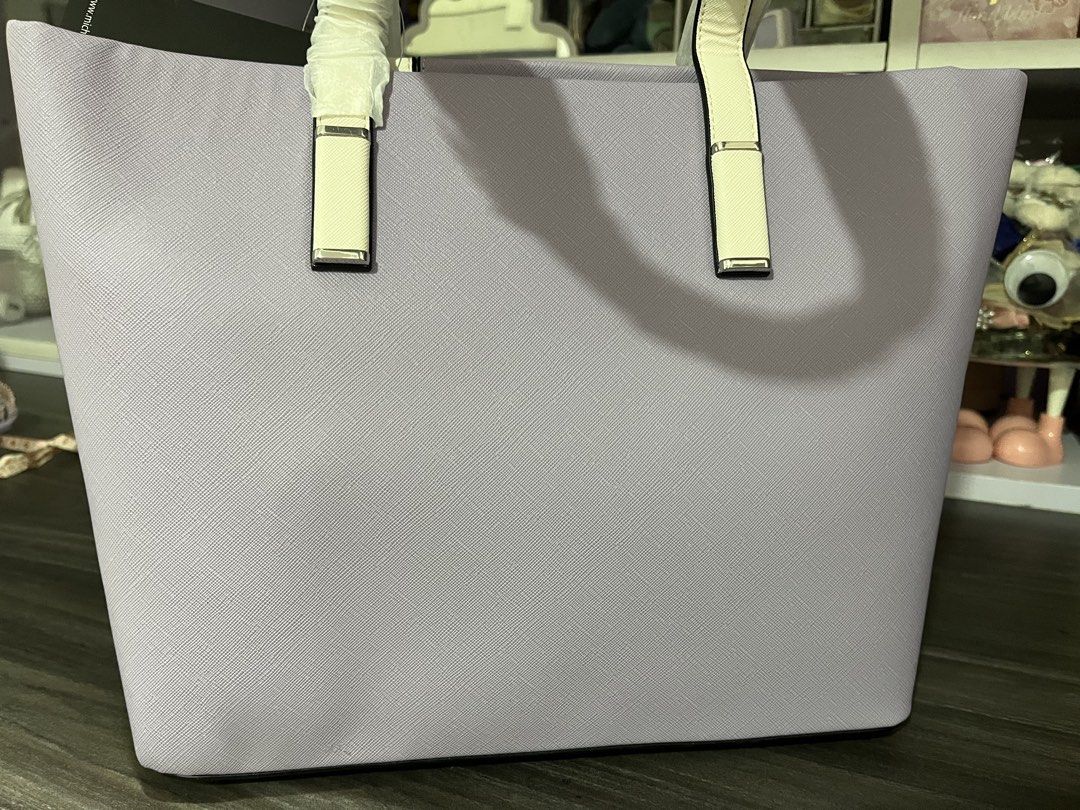 Michel Domit Tote Bag (Category: Tote Bags) located in Pasig City. Submitted by melaiski28 (Listing ID 1433698650, Image 3). Description: Stylish tote bag from Michel Domit. Features a color block design with purple, white, and light blue panels. Includes a zip closure and a branded interior lining. The bag has a top handle and a tag. Measurements: 14 inches wide, 10 inches tall, and 5 inches deep..
