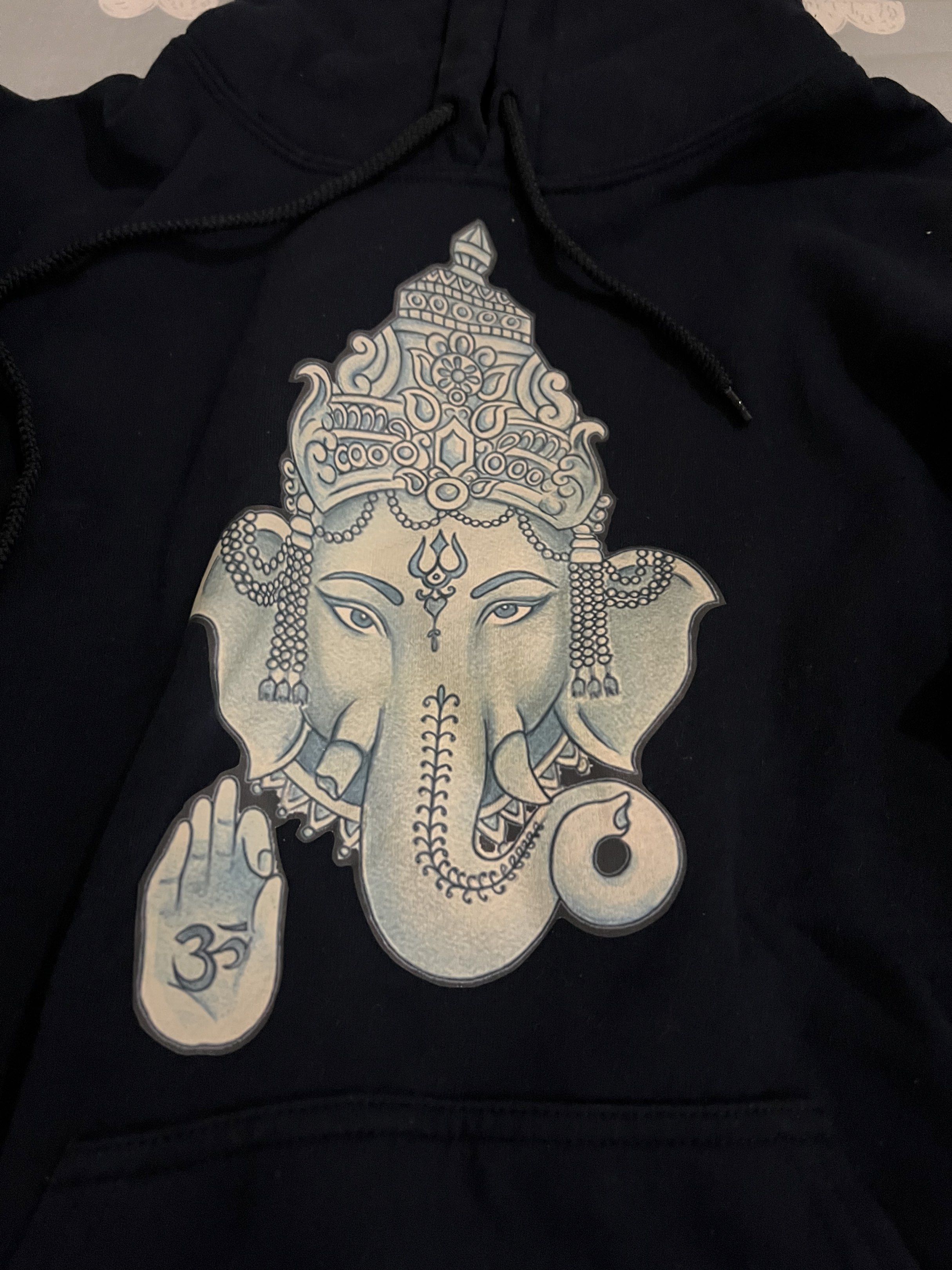 Navy Blue Ganesha Hoodie (Category: Coats, Jackets and Outerwear) located in Quezon City. Submitted by jade.young (Listing ID 1433659201, Image 2). Description: - Navy blue hoodie - Features a Ganesha graphic - Hooded with a front pocket - Black panels on sleeves - Comfortable material - Standard fit - Ideal for casual wear 21 x 24.5 size fits womens large.