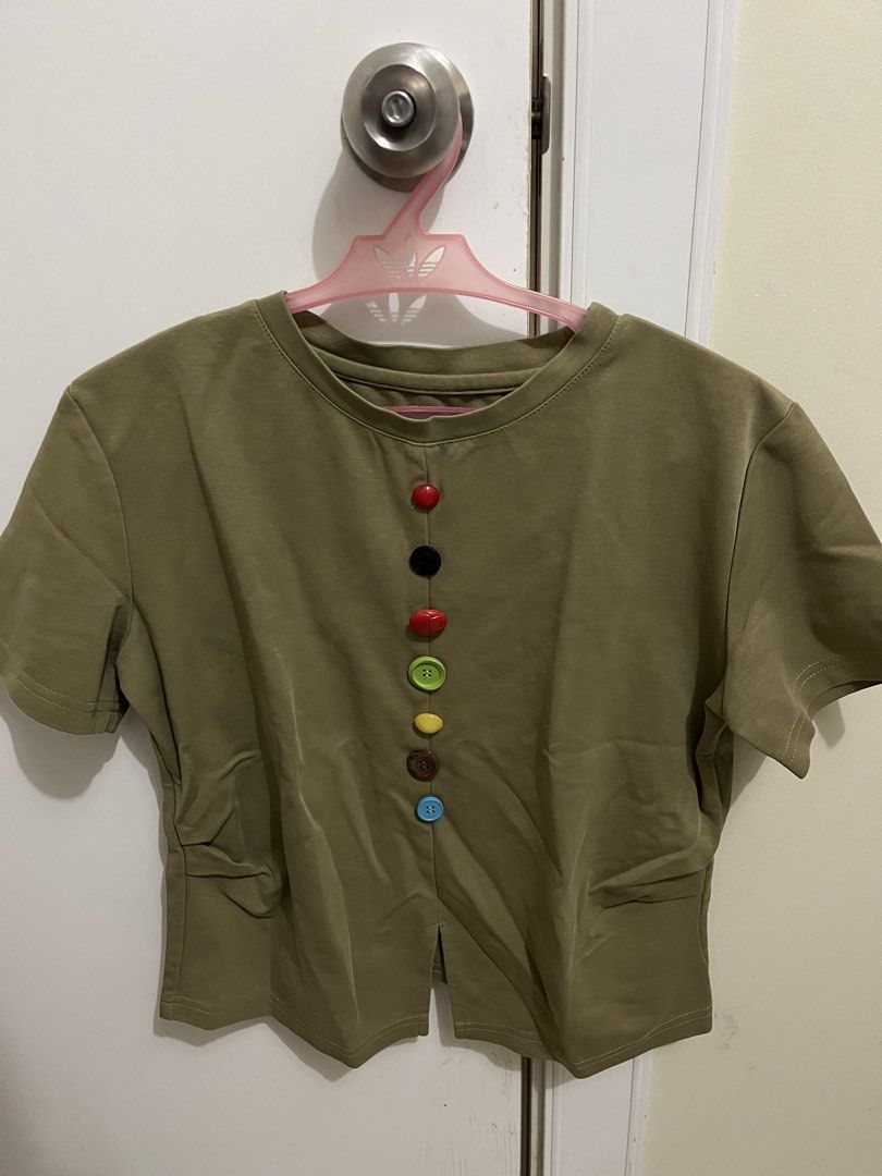 Olive Green Top with Colorful Buttons (Category: Blouses) located in Manila. Submitted by sweeterpotato77 (Listing ID 1433737870, Image 1). Description: - Olive green top -Size: Small - Round neckline - Short sleeves - Colorful buttons down the front - Split hem.