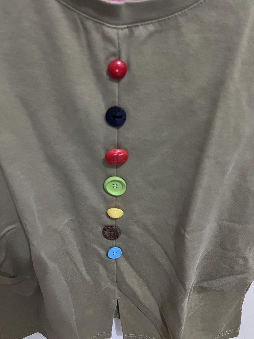 Olive Green Top with Colorful Buttons (Category: Blouses) located in Manila. Submitted by sweeterpotato77 (Listing ID 1433737870, Image 3). Description: - Olive green top -Size: Small - Round neckline - Short sleeves - Colorful buttons down the front - Split hem.