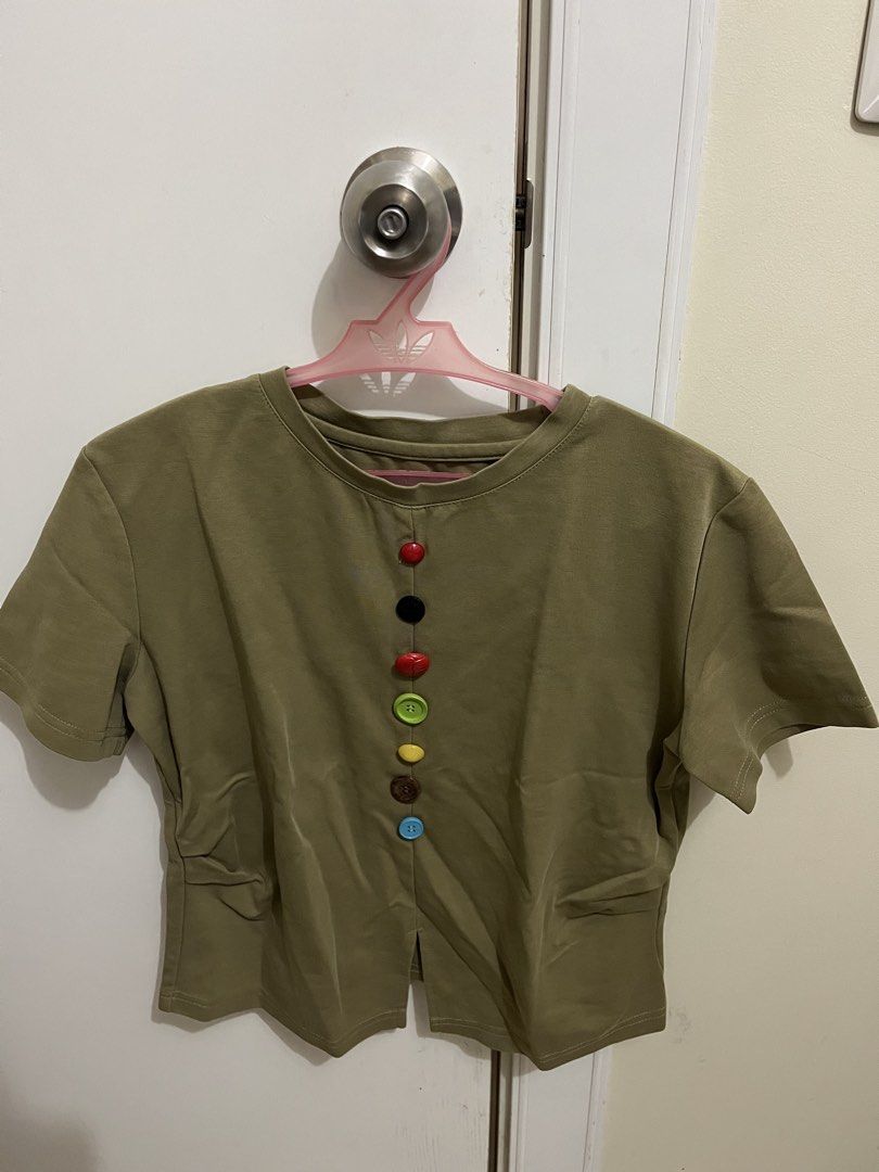 Olive Green Top with Colorful Buttons (Category: Blouses) located in Manila. Submitted by sweeterpotato77 (Listing ID 1433737870, Image 2). Description: - Olive green top -Size: Small - Round neckline - Short sleeves - Colorful buttons down the front - Split hem.