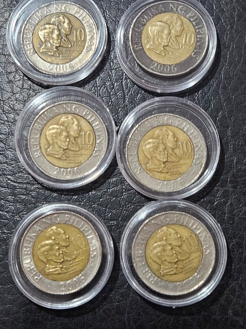 Philippine 10 Piso Coins 2006 (Category: Currency) located in Caloocan City. Submitted by rm.diaz (Listing ID 1433708458, Image 2). Description: - Collection of 2006 Philippine 10 Piso coins. - Features Apolinario Mabini and Andres Bonifacio. - Each coin is in a protective case. - Bi-metallic design: gold-colored center, silver-colored outer ring. - Coins display "REPUBLIKA NG PILIPINAS" and "10 PISO"..