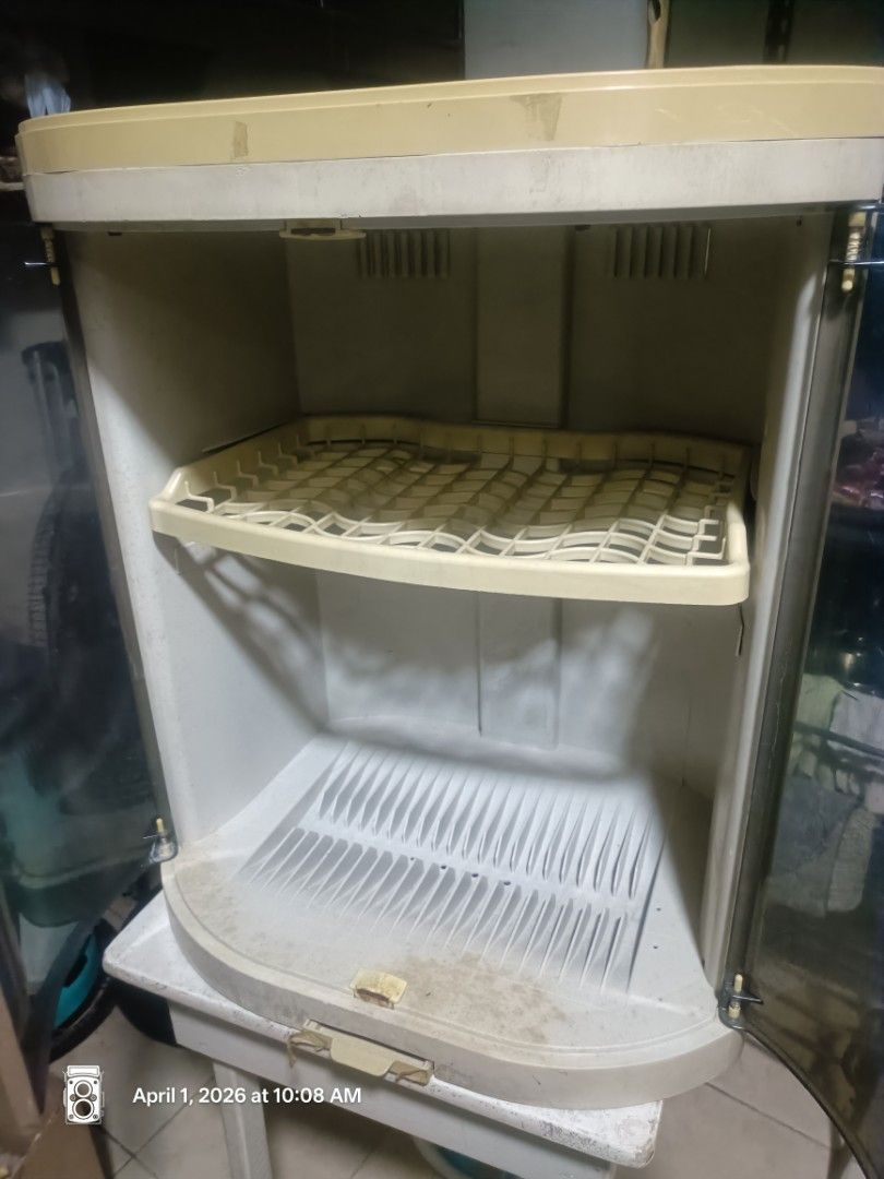 Plastic Dish Rack with Cover (Category: Food Organization & Storage) located in Quezon City. Submitted by sunshine.ning (Listing ID 1433753468, Image 2). Description: - Plastic dish rack with clear cover - Two shelves for drying dishes - Beige frame and white base - Slotted bottom for drainage - Includes two handles for easy opening - Practical kitchen organization solution.