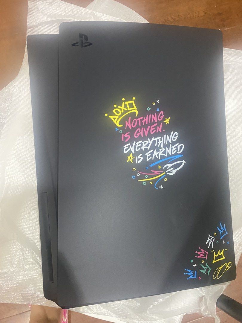 PlayStation 5 Console Cover LeBron James Edition (Category: PlayStation) located in Caloocan City. Submitted by cleverstar-9790 (Listing ID 1433658928, Image 1). Description: - Limited Edition PS5 Console Cover - Features LeBron James branding - Design: "Nothing is Given, Everything is Earned" - Color: Black with colorful graphics - Includes: Console cover and original packaging.