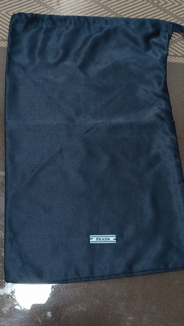 Prada Dust Bag 8.5"×14" (Category: Luxury Bags & Wallets) located in Santa Maria. Submitted by quinalva02 (Listing ID 1433603874, Image 1). Description: - Authentic Prada dust bag - Navy blue color - Features a drawstring closure - Includes small Prada logo label - Dimensions: approximately 8.5 x 14 inches - Ideal for protecting luxury items.