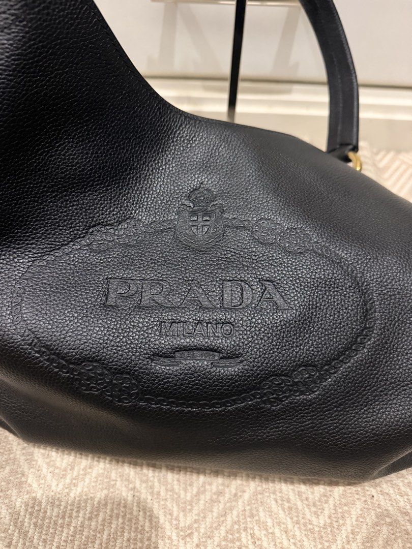 PRADA HOBO LEATHER BAG 🖤 (Category: Luxury Bags & Wallets) located in Taytay. Submitted by madamepean (Listing ID 1433732197, Image 3). Description: ORIGINAL PRADA HOBO LEATHER BAG🖤 with cards, dustbag, paperbag NFC tag LIKE NEW! Used once Bought for 130,000 Super steal!!! Super nice, elegant, not screaming luxury. If you know, you know kind of bag 🖤.