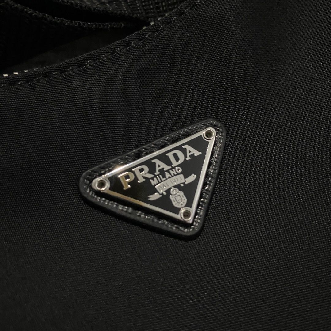 Prada Mini Tessuto Nylon Bag (Category: Luxury Bags & Wallets) located in Antipolo. Submitted by bentakahitanoano (Listing ID 1433684168, Image 2). Description: Prada Re-Edition Mini Nylon Bag Still in good condition. A coveted piece from the Re-Edition series, featuring Prada’s signature durable nylon fabric and the iconic triangular logo. A perfect blend of nostalgia and modern utility. Mini Shoulder Kili Kili Bag Condition. Good used condition