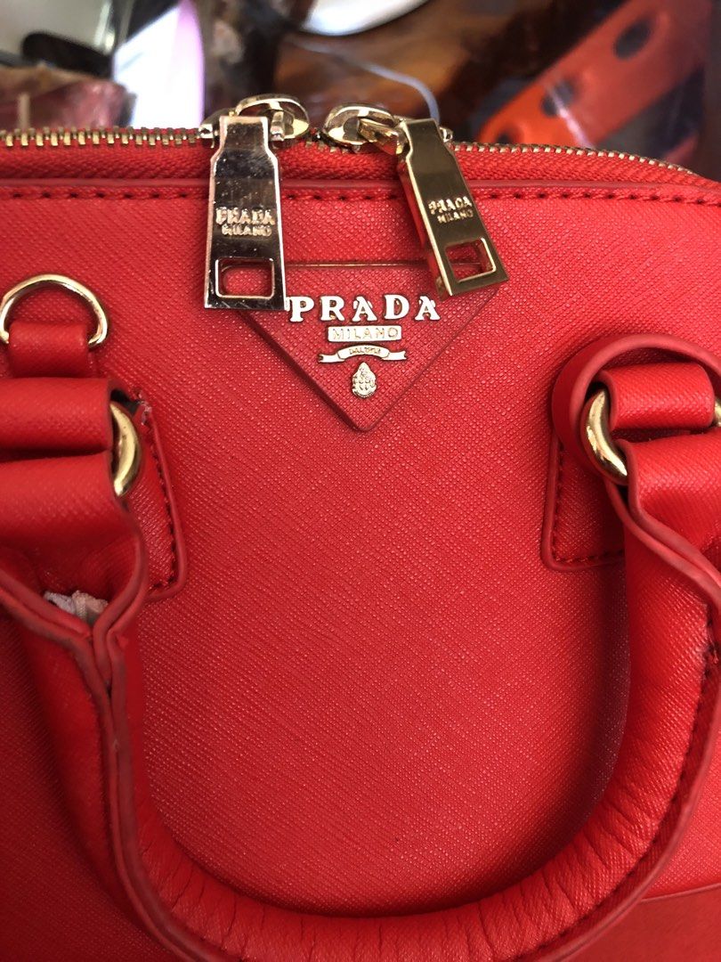 Red Handbag with Gold Studs (Category: Luxury Bags & Wallets) located in Tabuk. Submitted by qurst (Listing ID 1433632103, Image 1). Description: - Vibrant red handbag - Gold studs on the bottom - Smooth material - Rectangular shape - Well-made stitching.