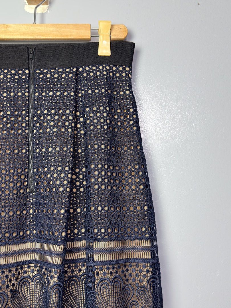 Self-Portrait Navy Lace Skirt (Category: Skirts) located in Manila. Submitted by dipdrip (Listing ID 1433735394, Image 2). Description: - Self-Portrait navy lace skirt - Flattering A-line silhouette - Intricate floral and geometric lace detailing - Hidden zipper closure - Convenient pockets - Nude-colored lining - Size: UK 14, US 10 DIMENSION Waist : 28 Length : 26 Condition In excellent condition 2,500php Negotiable Open for COD via Lalamove aro