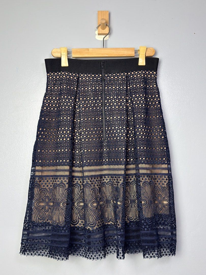 Self-Portrait Navy Lace Skirt (Category: Skirts) located in Manila. Submitted by dipdrip (Listing ID 1433735394, Image 1). Description: - Self-Portrait navy lace skirt - Flattering A-line silhouette - Intricate floral and geometric lace detailing - Hidden zipper closure - Convenient pockets - Nude-colored lining - Size: UK 14, US 10 DIMENSION Waist : 28 Length : 26 Condition In excellent condition 2,500php Negotiable Open for COD via Lalamove aro