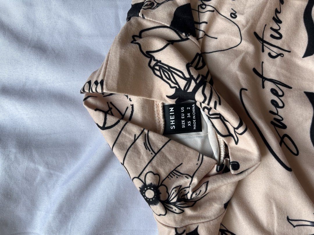 Shein Tattoo Print Crop Top (Category: Others Tops) located in Las Pinas. Submitted by nixxxxx (Listing ID 1433672567, Image 2). Description: - Shein crop top - Used once - Unique tattoo print design - Long sleeves - Mock neck - Beige color with black tattoo graphics.