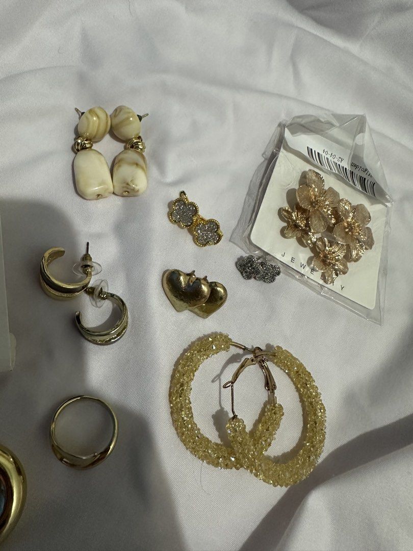 Take all for 150 only!! (Category: Earrings) located in Pasay City. Submitted by j9declutter (Listing ID 1433719240, Image 3). Description: Decluttering! Selling low!!! Pick-up via grab/move it/joyride/angkas/lalamove. Meet-up location: Lrt Edsa station NO COD! If in doubt, wag bumili 😁 You can pay thru BPi & Gcash only. Happy shopping! ❤️❤️❤️ - Gold-toned earring and accessory collection. - Features: - Large flower earrings - Hoop earrings - St