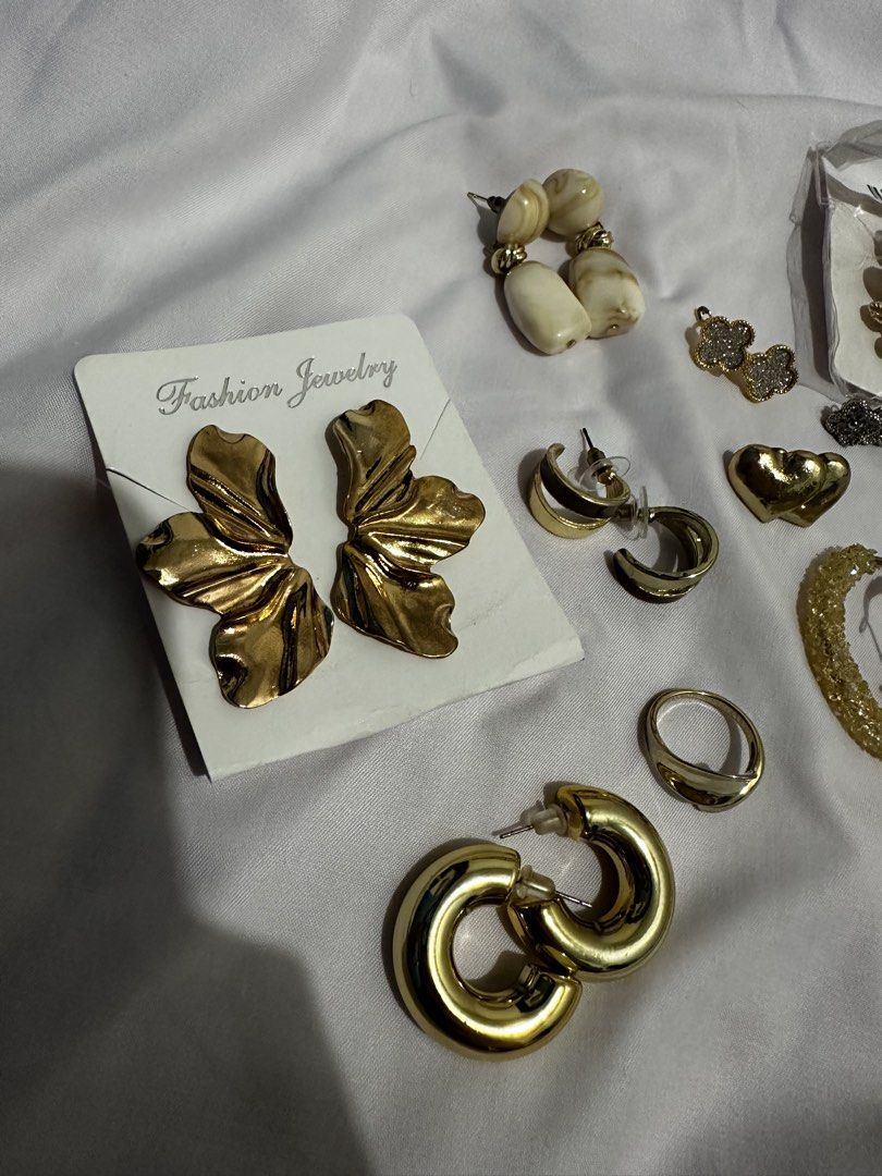 Take all for 150 only!! (Category: Earrings) located in Pasay City. Submitted by j9declutter (Listing ID 1433719240, Image 2). Description: Decluttering! Selling low!!! Pick-up via grab/move it/joyride/angkas/lalamove. Meet-up location: Lrt Edsa station NO COD! If in doubt, wag bumili 😁 You can pay thru BPi & Gcash only. Happy shopping! ❤️❤️❤️ - Gold-toned earring and accessory collection. - Features: - Large flower earrings - Hoop earrings - St