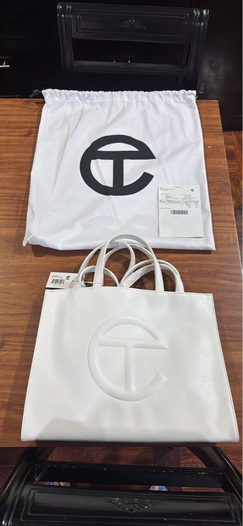 Telfar Shopping Bag White (Category: Luxury Bags & Wallets) located in Manila. Submitted by rods10 (Listing ID 1433758919, Image 1). Description: - White Telfar Shopping Bag - Features Telfar logo - Includes dust bag and tags - Double handles - Rectangular shape - Multiple interior compartments - Includes matching white pouch.