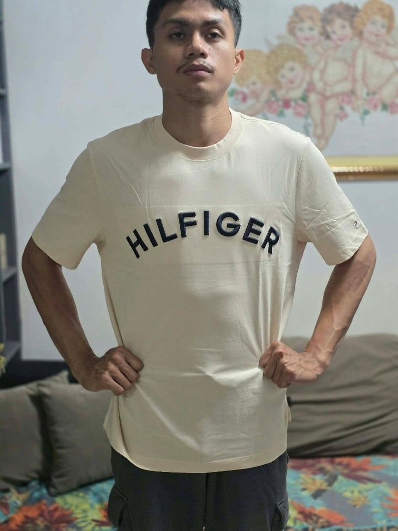 Tommy Hilfiger Regular Fit T-shirt (Category: Tshirts & Polo Shirts ) located in Antipolo. Submitted by tikboy5112 (Listing ID 1433582620, Image 1). Description: - Cream-colored Tommy Hilfiger T-shirt - Bold, black Tommy Hilfiger logo on the chest - Regular fit - Crew neck - Small Tommy Hilfiger detail at the back neckline - Includes original tags.