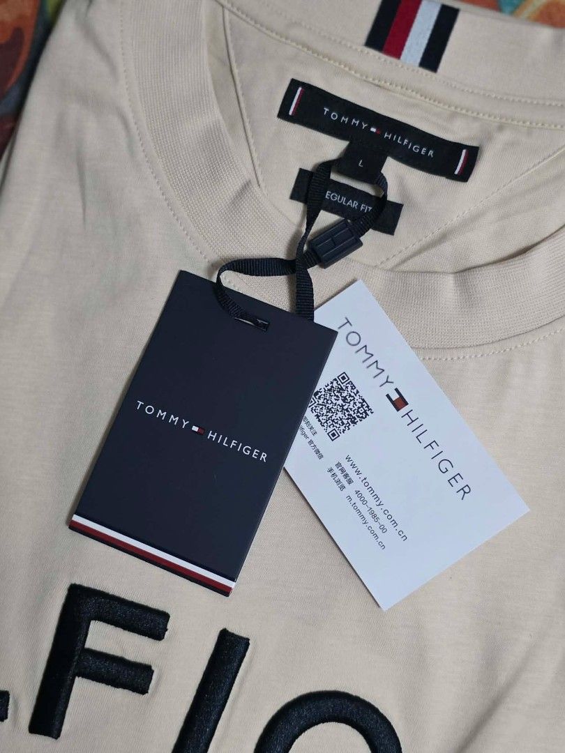 Tommy Hilfiger Regular Fit T-shirt (Category: Tshirts & Polo Shirts ) located in Antipolo. Submitted by tikboy5112 (Listing ID 1433582620, Image 3). Description: - Cream-colored Tommy Hilfiger T-shirt - Bold, black Tommy Hilfiger logo on the chest - Regular fit - Crew neck - Small Tommy Hilfiger detail at the back neckline - Includes original tags.