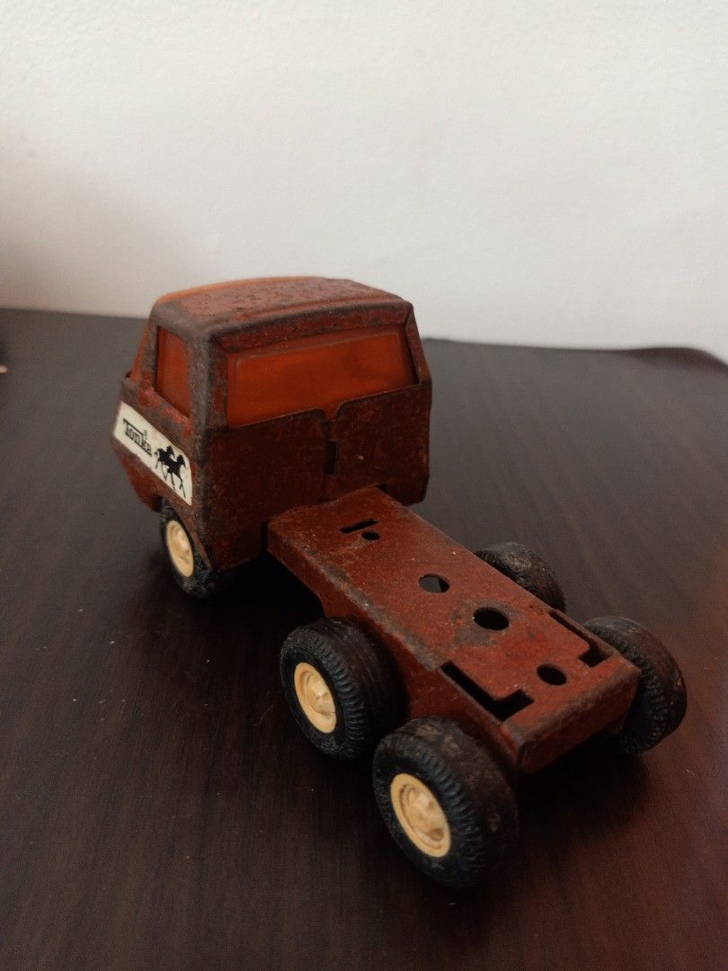 Tonka Truck (Category: Vehicle & Diecast Models) located in Las Pinas. Submitted by the_recycle_shop (Listing ID 1433632024, Image 2). Description: - Vintage Tonka truck - Brown cab and trailer - Six wheels - White grill - Tonka logo and horse emblem visible - Shows wear and tear.