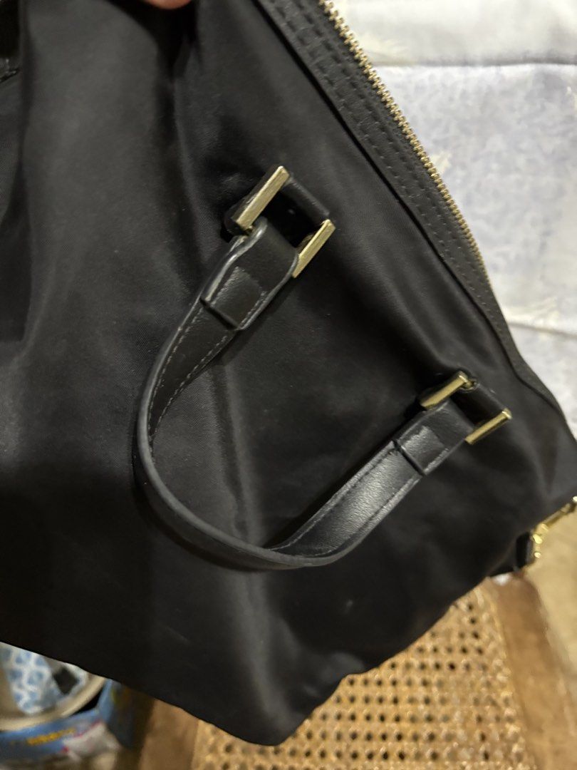Tory Burch Black Handbag with Shoulder Strap (Category: Luxury Bags & Wallets) located in Plaridel. Submitted by patty126 (Listing ID 1433599142, Image 3). Description: - Black handbag - Gold-tone hardware - Front zipper pocket - Top zipper closure - Detachable shoulder strap - Interior pocket - Tory Burch logo - Includes red tag.
