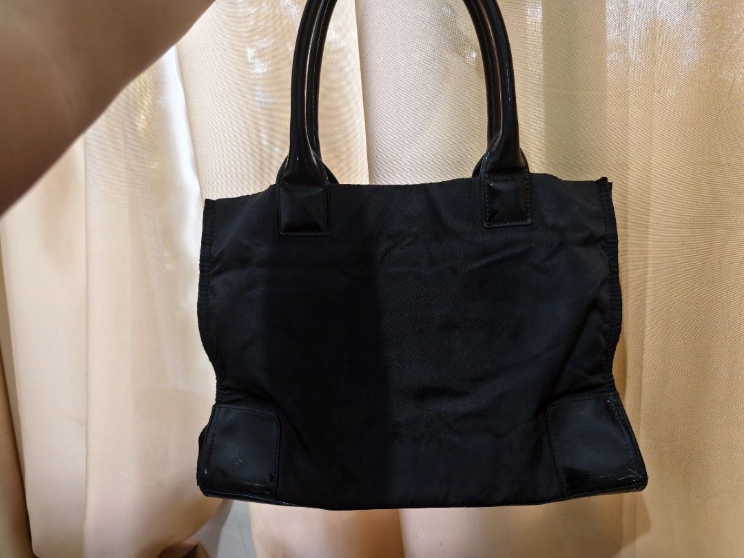 Tory Burch Ella Black Tote Bag (Category: Luxury Bags & Wallets) located in Manila. Submitted by findswithalcloset (Listing ID 1433723038, Image 3). Description: - Black Tory Burch tote bag - Large logo on the front - Patent leather accents - Interior zip pocket - Some interior stains - Handles show wear - Stylish and functional for everyday use -naputol na din yung jelly tag nya sa sobrang gamit😅.