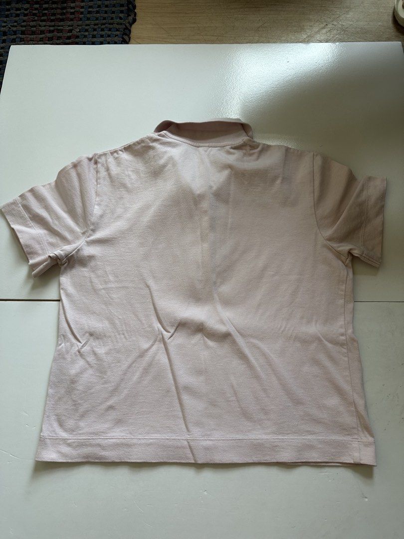 Uniqlo Polo Shirt (Category: Tshirts & Polo Shirts ) located in Manila. Submitted by lzngzlvr (Listing ID 1433653987, Image 3). Description: - Uniqlo polo shirt - Light pink color - Collared neckline - Short sleeves - Button-up closure - Made in Vietnam - Soft, comfortable fabric - Ideal for casual wear.