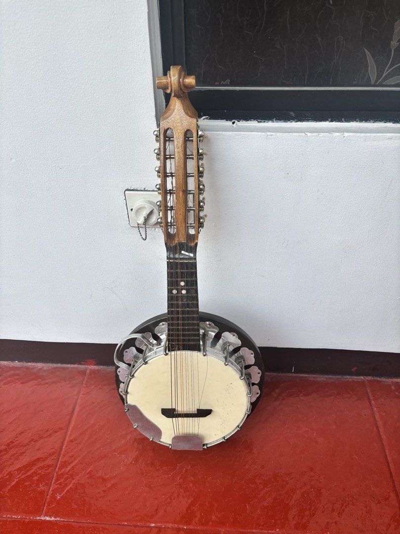 Vintage Banjo Mandolin Bandurria (Category: Musical Instruments) located in Quezon City. Submitted by kislaptrends (Listing ID 1433609713, Image 2). Description: - Vintage banjo mandolin - Wooden neck and body - Cream-colored face - Multiple strings and tuning pegs - Round body with metal accents -Lenght: 62cm Pick up only 📍Fairview QC.