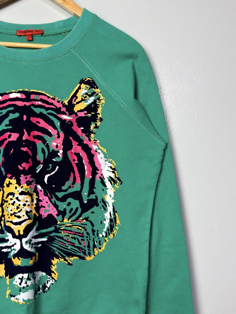 Vivienne Tam Tiger Print Sweatshirt (Category: Longsleeves) located in Manila. Submitted by dipdrip (Listing ID 1433735392, Image 2). Description: - Vivienne Tam Tiger Print Sweatshirt - Size: M - Features a bold and colorful tiger design - Stylish green color - Made of 100% cotton - A unique and fashionable piece DIMENSIONS Width : 21 Length : 24.5 Sleeves : 27.5 Shoulder : 18 Condition In verygood condition 800php Negotiable Open for COD via La