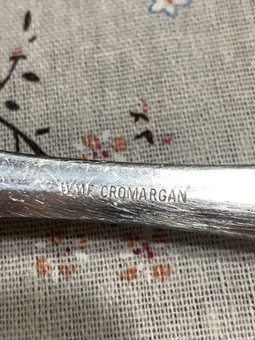 WMF Cromargan Slotted Spatula (Category: Bakeware) located in San Mateo. Submitted by kusinaninanan (Listing ID 1433729098, Image 3). Description: WMF Cromargan slotted spatula is perfect for flipping and serving food. It features a stainless steel construction with a comfortable handle and a convenient hanging loop. The spatula has a slotted design for draining excess oil or liquid. It is approximately 12 inches long. The WMF logo is visible on 