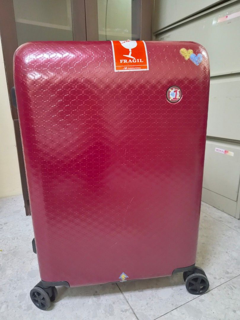 World Traveller - Berry Red Suitcase (Medium) (Category: Luggage) located in Las Pinas. Submitted by ajbash (Listing ID 1433665837, Image 1). Description: - 8/10 condition -Medium size - signs of sticker marks Width 18 inches Length 25.5 inches Thickness 11 inches -Sign of usage.