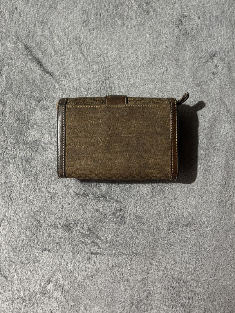 Authentic Coach Signature Wallet (Vintage Style) (Category: Luxury Bags & Wallets) located in Manila. Submitted by elianner (Listing ID 1429704570, Image 2). Description: Authentic Coach wallet in the classic old signature monogram design 🤎 Features brown canvas with leather trim and a unique buckle detail and super timeless. ✔️ Original Coach ✔️ Old signature design (harder to find na) ✔️ Spacious – fits cards, cash, and more ✔️ Durable canvas 