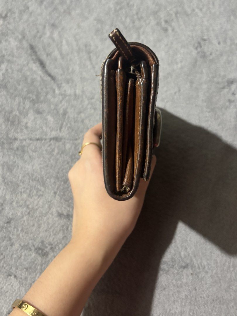 Authentic Coach Signature Wallet (Vintage Style) (Category: Luxury Bags & Wallets) located in Manila. Submitted by elianner (Listing ID 1429704570, Image 3). Description: Authentic Coach wallet in the classic old signature monogram design 🤎 Features brown canvas with leather trim and a unique buckle detail and super timeless. ✔️ Original Coach ✔️ Old signature design (harder to find na) ✔️ Spacious – fits cards, cash, and more ✔️ Durable canvas 