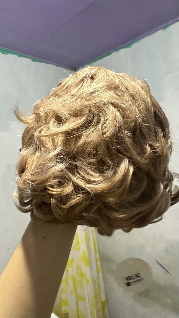 Blonde Curly Wig (Category: Hair Accessories) located in Angeles City. Submitted by clmsnw01 (Listing ID 1431966829, Image 3). Description: - Short, curly blonde wig. - Made with synthetic fibers. - Features loose curls and a natural hairline. - Comfortable and ready to wear..