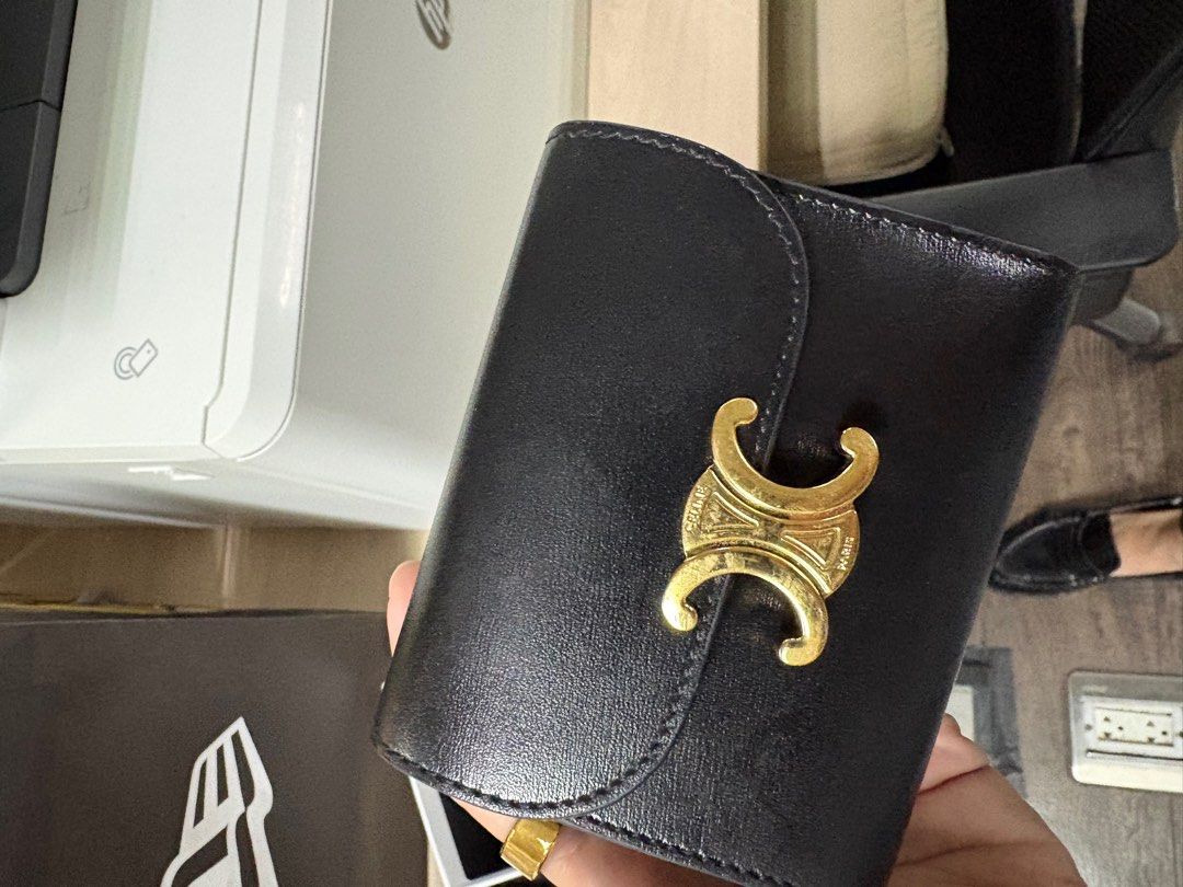 Celine Triomphe Wallet (Category: Luxury Bags & Wallets) located in Manila. Submitted by emceebee (Listing ID 1433876191, Image 1). Description: - Authentic Celine Triomphe wallet - Color: Black - Features: - Gold-tone clasp - Celine logo - Includes: Dust bag and receipt from Hyundai Duty Free - Made in Italy - Multiple compartments for cards and cash.