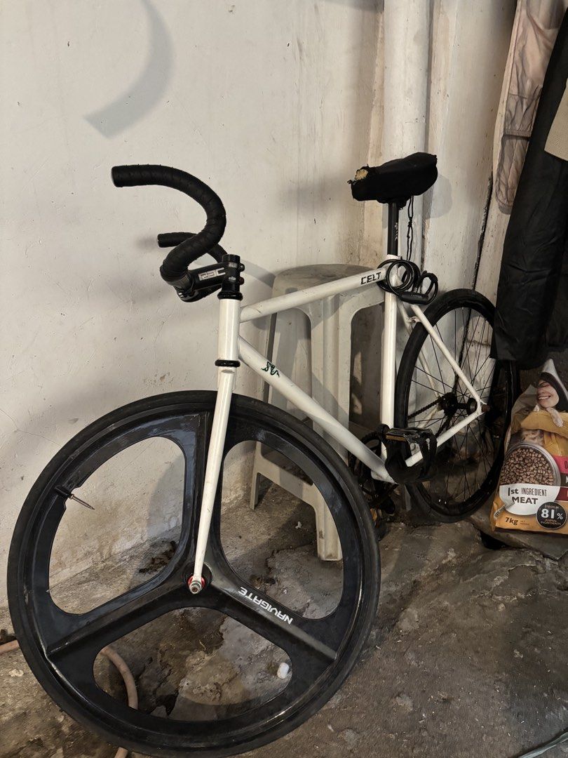 Celt Fixed Gear Bike with Tri-Spoke Wheel (Category: Bicycles) located in Manila. Submitted by namartiriv06966 (Listing ID 1433890886, Image 2). Description: - White Celt fixed gear bike - Tri-spoke front wheel - Black handlebar - Black seat - Minimalist design - Suitable for city riding - Includes rear wheel, chain, and pedals.