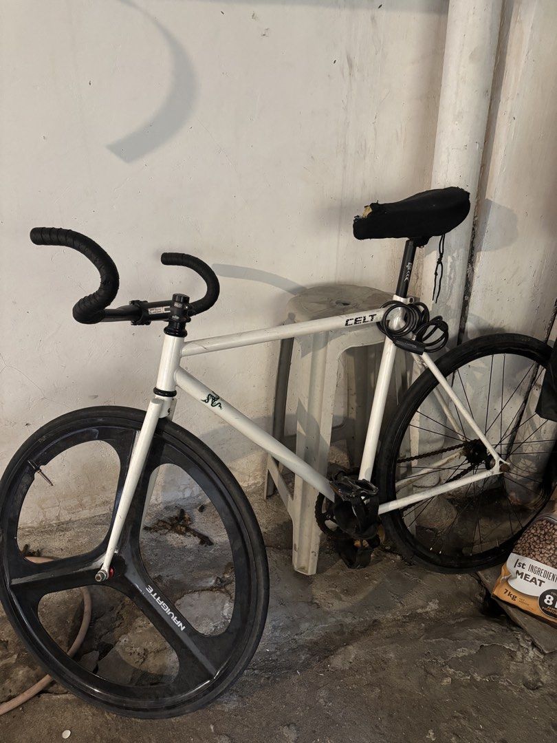 Celt Fixed Gear Bike with Tri-Spoke Wheel (Category: Bicycles) located in Manila. Submitted by namartiriv06966 (Listing ID 1433890886, Image 1). Description: - White Celt fixed gear bike - Tri-spoke front wheel - Black handlebar - Black seat - Minimalist design - Suitable for city riding - Includes rear wheel, chain, and pedals.
