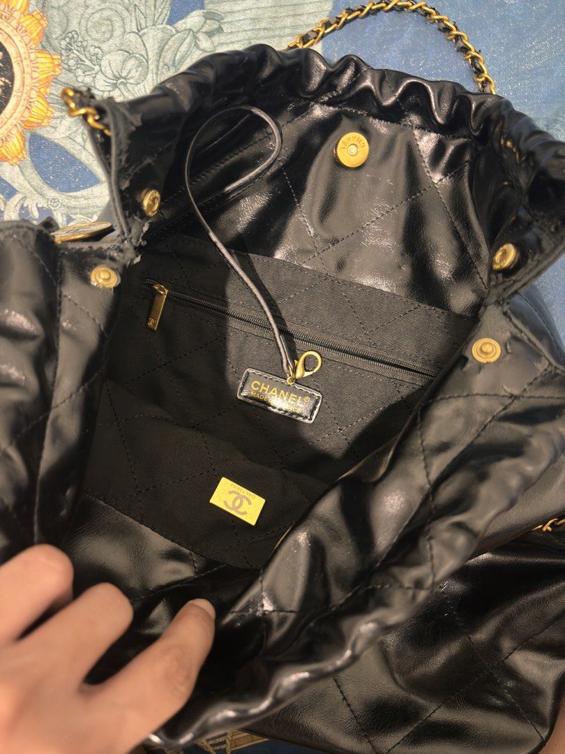 Chanel 22 Drawstring Bag Black (Category: Luxury Bags & Wallets) located in Caloocan City. Submitted by gonzalesao81472 (Listing ID 1433886272, Image 3). Description: - Chanel 22 Drawstring Bag - Classic black color - Elegant gold-tone hardware - Iconic quilted design with Chanel logo - Convenient chain strap - Secure drawstring closure - Interior zippered pocket - Minor wear on corners and edges - Can't find the pouch - with dustbag .