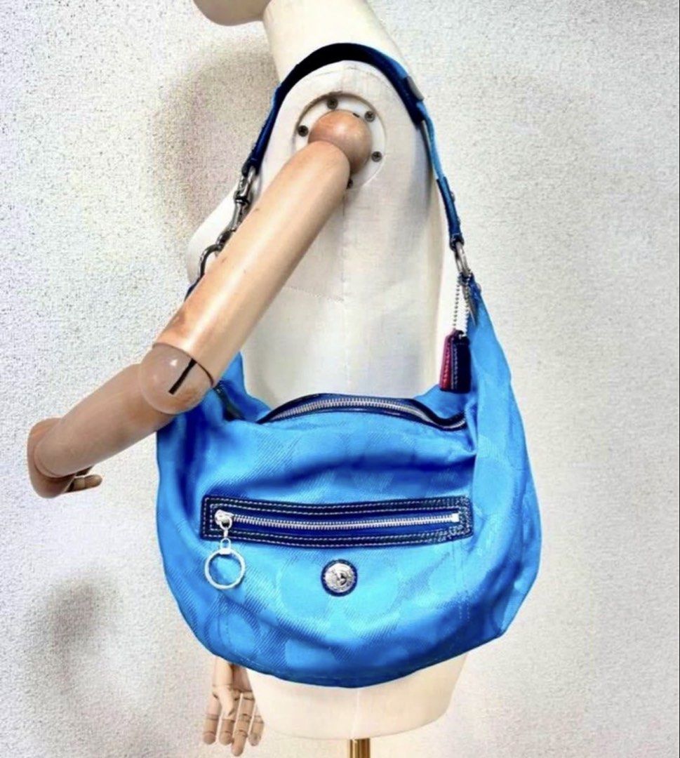 coach bag (Category: Shoulder Bags) located in Pasay City. Submitted by taptooload (Listing ID 1433820127, Image 2). Description: - Coach shoulder bag - Vibrant blue color with signature pattern - Zippered main compartment - Front pocket with silver zipper - Silver ring detail - Coach logo emblem - Adjustable strap with silver hardware.